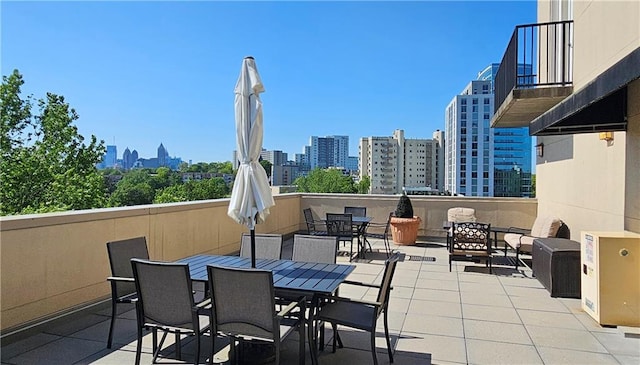 view of patio / terrace with a view of city and outdoor dining area