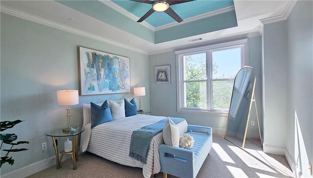 bedroom with visible vents, baseboards, ornamental molding, and a raised ceiling