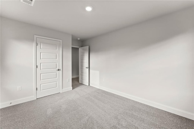 unfurnished bedroom with carpet, visible vents, and baseboards