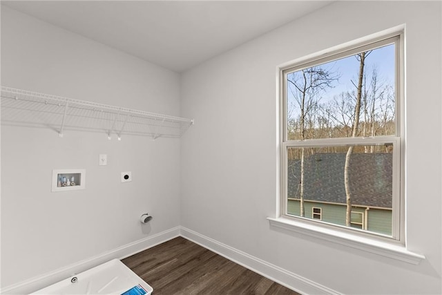 clothes washing area featuring laundry area, baseboards, dark wood-type flooring, hookup for a washing machine, and hookup for an electric dryer