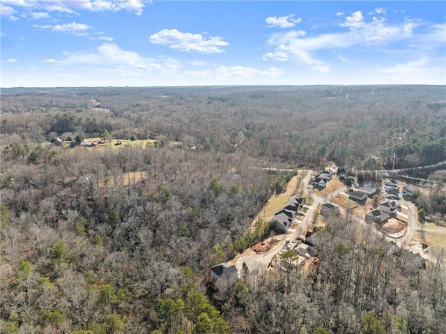 drone / aerial view featuring a wooded view