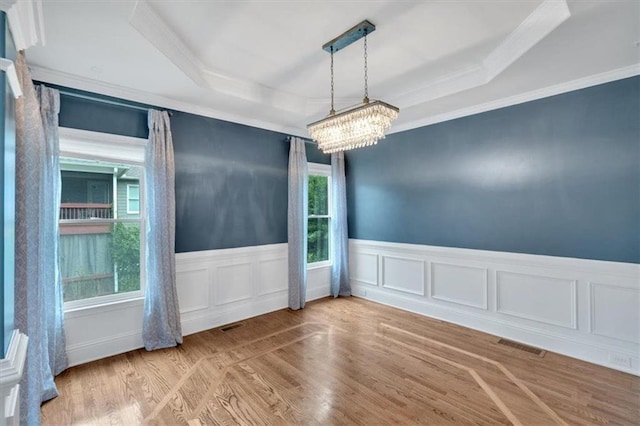 212 Thorncliff Way, Acworth, GA 30101 - spare room with a raised ceiling, crown molding, a chandelier, wainscoting, and wood finished floors