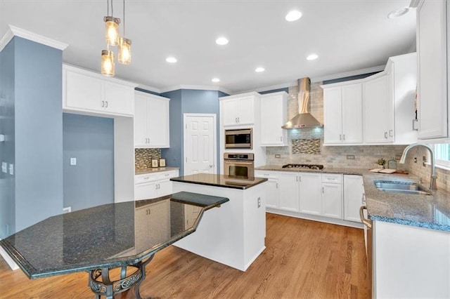 212 Thorncliff Way, Acworth, GA 30101 - kitchen featuring wall chimney range hood, appliances with stainless steel finishes, ornamental molding, light wood-style floors, and decorative backsplash