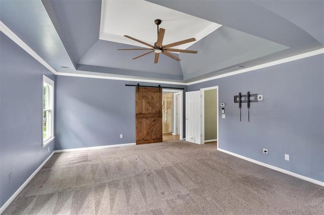 212 Thorncliff Way, Acworth, GA 30101 - unfurnished bedroom with a raised ceiling, a barn door, carpet floors, and a ceiling fan