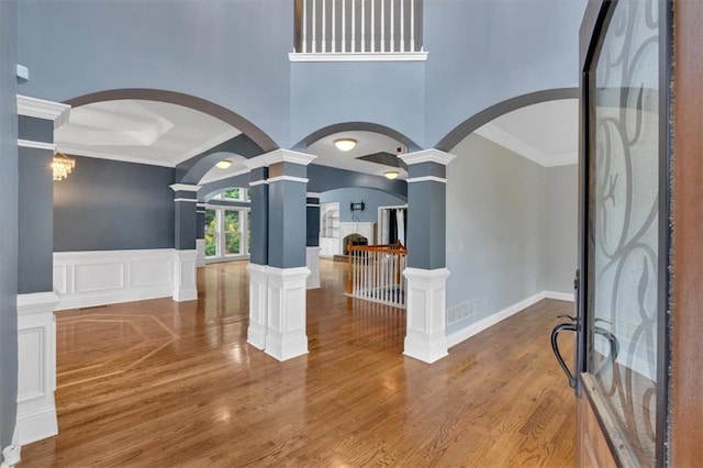212 Thorncliff Way, Acworth, GA 30101 - entryway featuring decorative columns, arched walkways, ornamental molding, wood finished floors, and a decorative wall
