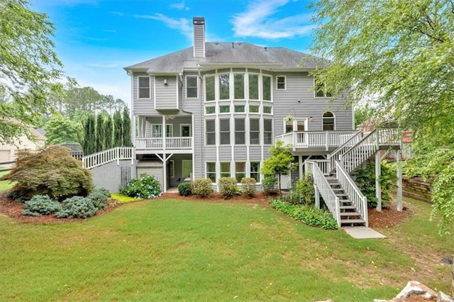 212 Thorncliff Way, Acworth, GA 30101 - rear view of house featuring a chimney, a yard, stairs, and a wooden deck