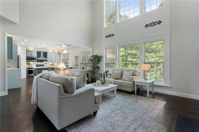 5828 Paliser Trce, Sugar Hill, GA 30518 - living room with a towering ceiling, dark wood finished floors, baseboards, and ceiling fan