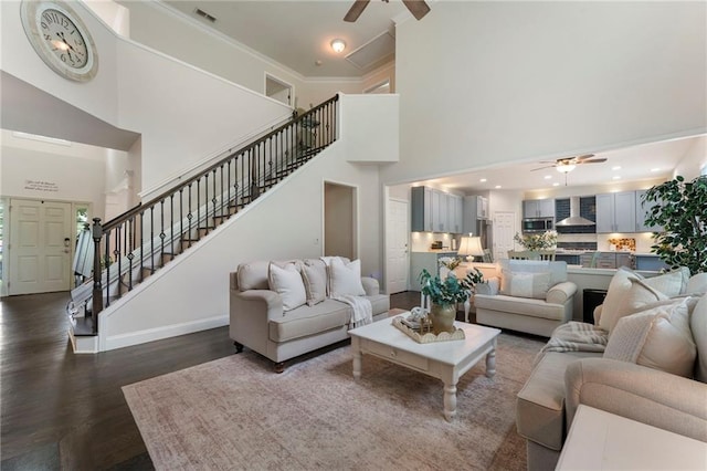 5828 Paliser Trce, Sugar Hill, GA 30518 - living room featuring ceiling fan, stairway, dark wood-type flooring, a towering ceiling, and ornamental molding