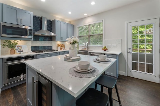 5828 Paliser Trce, Sugar Hill, GA 30518 - kitchen featuring wall chimney exhaust hood, appliances with stainless steel finishes, wine cooler, a sink, and recessed lighting