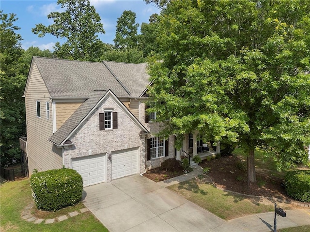 5828 Paliser Trce, Sugar Hill, GA 30518 - view of front facade featuring driveway, a shingled roof, a garage, stone siding, and covered porch