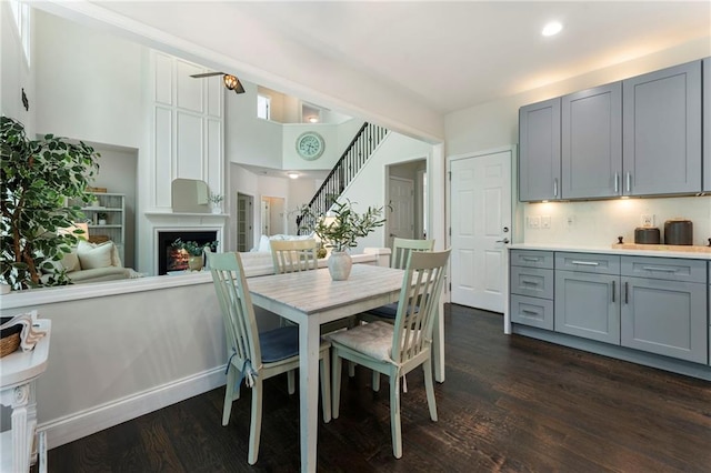 5828 Paliser Trce, Sugar Hill, GA 30518 - dining space featuring dark wood-style floors, stairway, a large fireplace, and recessed lighting