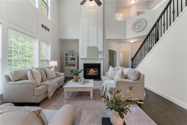 5828 Paliser Trce, Sugar Hill, GA 30518 - living area with a high ceiling, baseboards, ceiling fan, a large fireplace, and wood finished floors