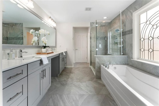 5828 Paliser Trce, Sugar Hill, GA 30518 - bathroom featuring double vanity, a shower stall, a garden tub, baseboards, and marble finish floors