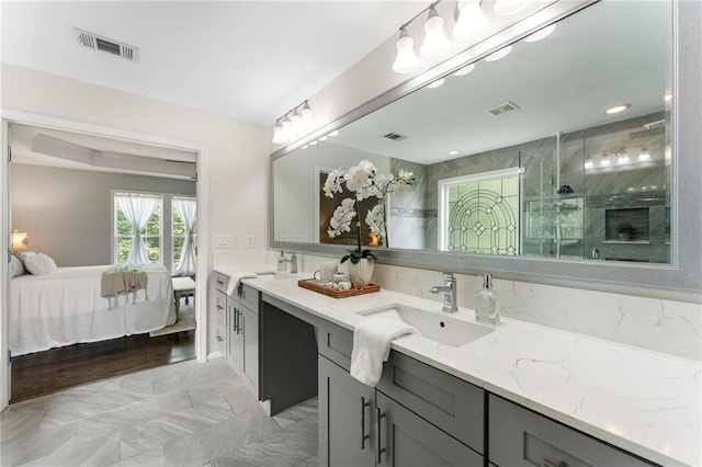 5828 Paliser Trce, Sugar Hill, GA 30518 - bathroom with double vanity, ensuite bathroom, an enclosed shower, and marble look tiles