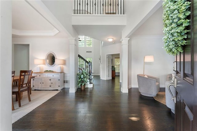 5828 Paliser Trce, Sugar Hill, GA 30518 - entryway with a towering ceiling, ornate columns, dark wood-style flooring, stairs, and baseboards