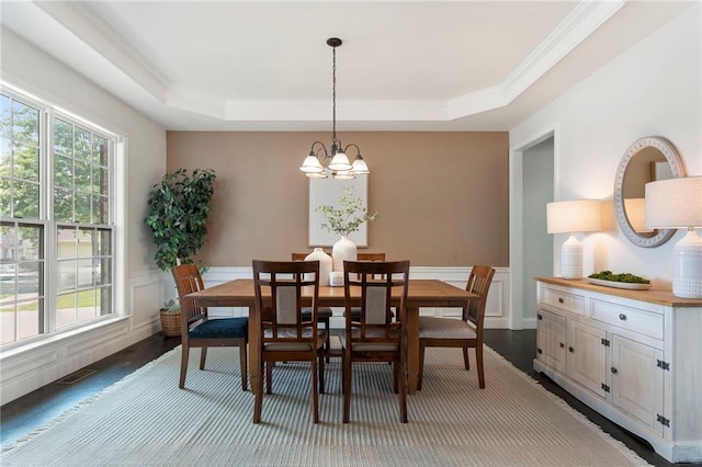 5828 Paliser Trce, Sugar Hill, GA 30518 - dining room featuring wood finished floors, a chandelier, a tray ceiling, crown molding, and a wainscoted wall