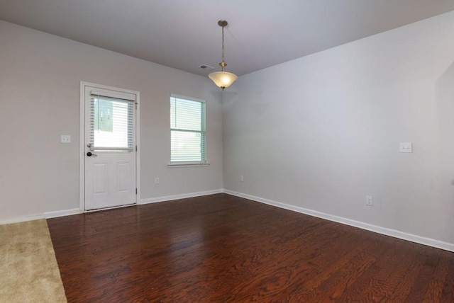 empty room with dark wood-type flooring