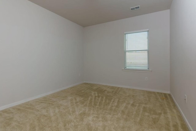 empty room featuring light carpet