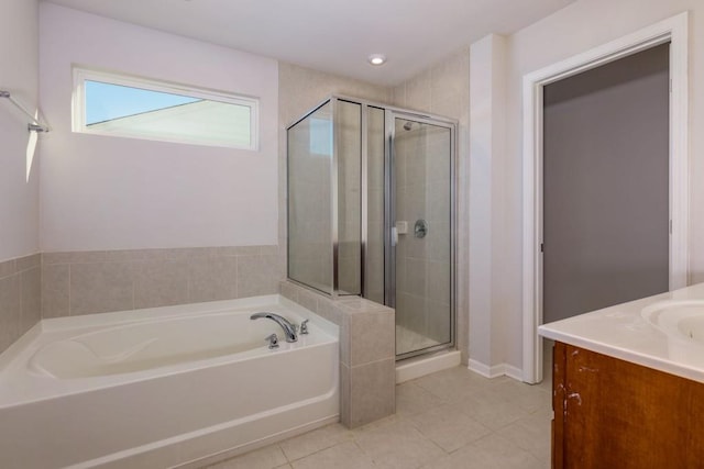 bathroom with tile patterned flooring, independent shower and bath, and vanity