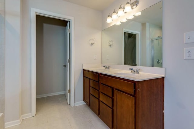 bathroom featuring tile patterned flooring, walk in shower, and vanity