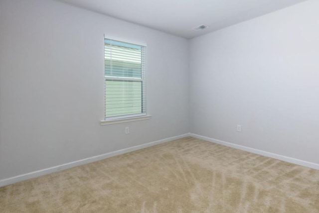 empty room featuring light colored carpet