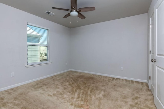 carpeted spare room featuring ceiling fan