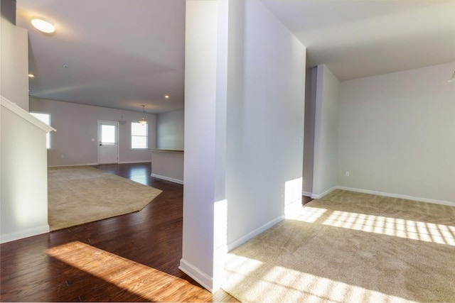 spare room with a notable chandelier and wood-type flooring