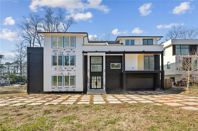 rear view of house featuring a garage