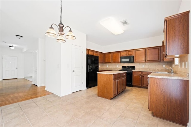 kitchen with visible vents, decorative backsplash, light countertops, black appliances, and a sink