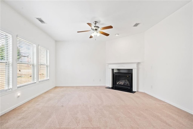 unfurnished living room with baseboards, a fireplace with flush hearth, visible vents, and carpet flooring