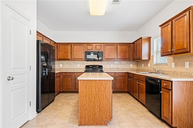 kitchen featuring a center island, light countertops, backsplash, a sink, and black appliances