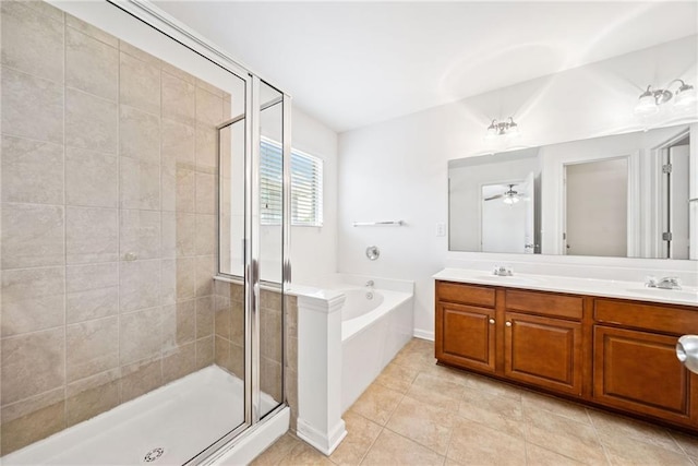 bathroom featuring double vanity, a garden tub, tile patterned flooring, a shower stall, and a sink