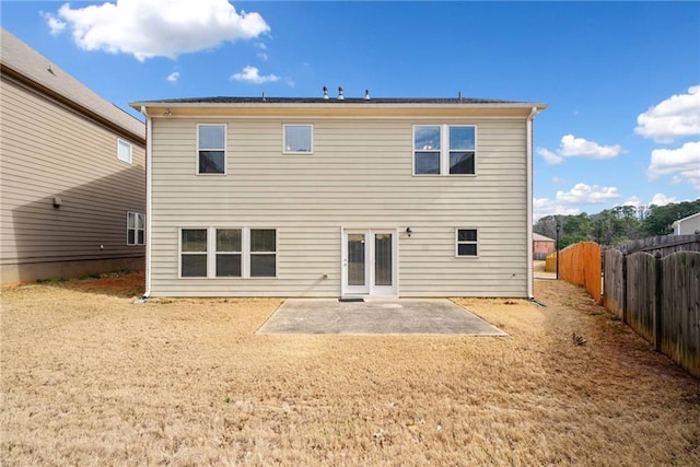rear view of house featuring a patio area and fence