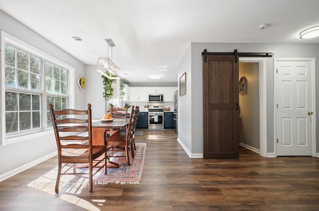 537 Autumn Ridge Dr, Canton, GA 30115 - dining space featuring a barn door, baseboards, dark wood-style floors, and a textured ceiling