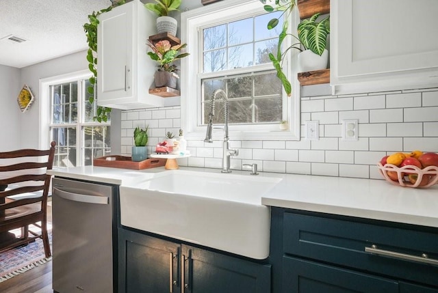 537 Autumn Ridge Dr, Canton, GA 30115 - kitchen with dishwasher, a sink, healthy amount of natural light, light countertops, and a textured ceiling