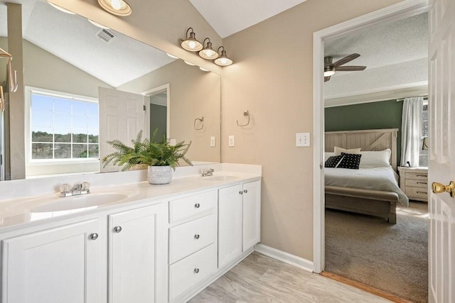 537 Autumn Ridge Dr, Canton, GA 30115 - ensuite bathroom featuring ceiling fan, vaulted ceiling, double vanity, and baseboards
