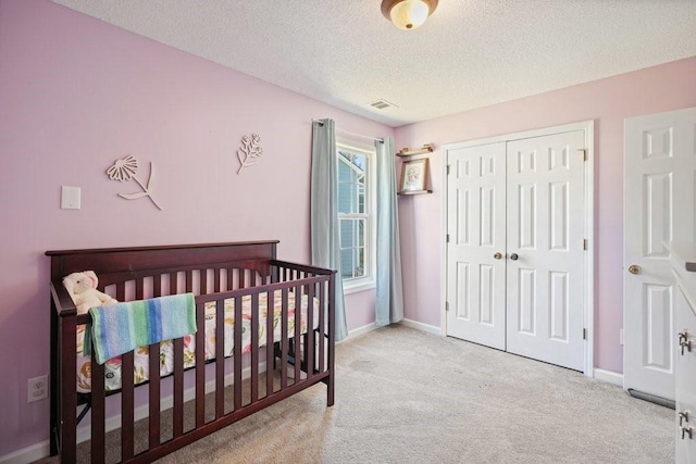 537 Autumn Ridge Dr, Canton, GA 30115 - bedroom featuring carpet flooring, a closet, baseboards, and a textured ceiling