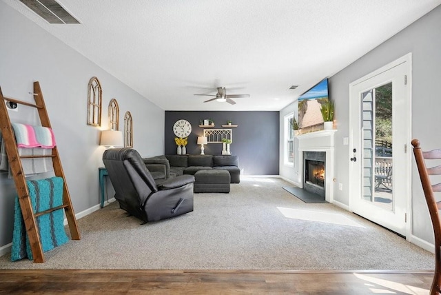 537 Autumn Ridge Dr, Canton, GA 30115 - living area featuring a fireplace with flush hearth, carpet flooring, a ceiling fan, and baseboards