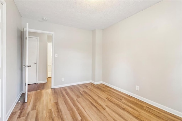 6071 Cristie Dr, Ellenwood, GA 30294 - unfurnished room with light wood-style floors, a textured ceiling, and baseboards