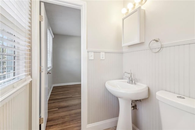 6071 Cristie Dr, Ellenwood, GA 30294 - bathroom with wainscoting, toilet, wood finished floors, and baseboards
