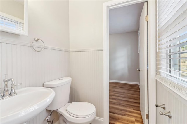 6071 Cristie Dr, Ellenwood, GA 30294 - half bath with a sink, a wainscoted wall, toilet, and wood finished floors