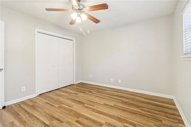 6071 Cristie Dr, Ellenwood, GA 30294 - unfurnished bedroom with light wood finished floors, baseboards, a closet, and a ceiling fan