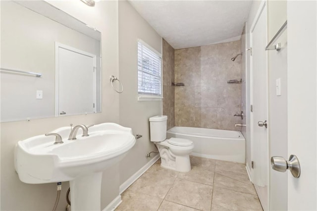 6071 Cristie Dr, Ellenwood, GA 30294 - bathroom with baseboards, toilet, tile patterned floors, shower / tub combination, and a sink