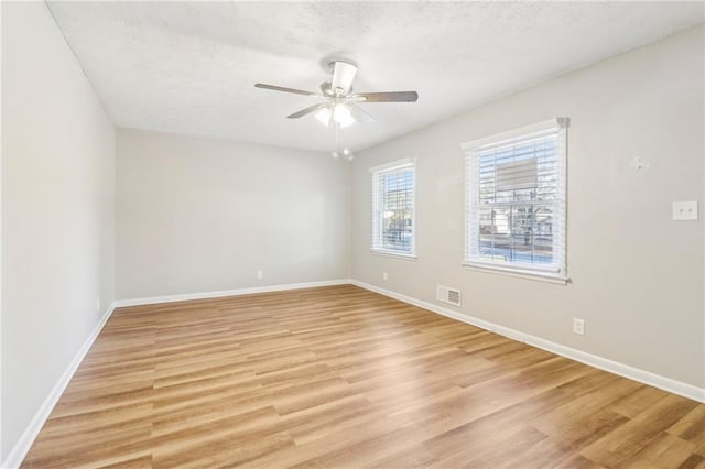 6071 Cristie Dr, Ellenwood, GA 30294 - unfurnished room featuring a ceiling fan, light wood-type flooring, baseboards, and a textured ceiling