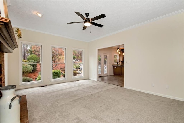 unfurnished room featuring ornamental molding, carpet, a textured ceiling, and ceiling fan