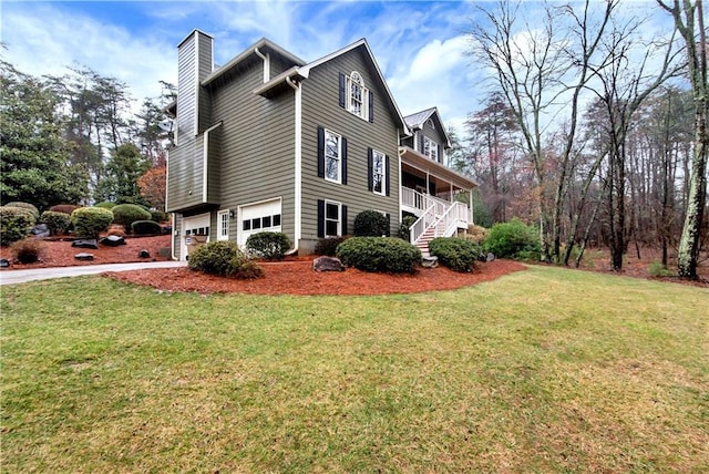 view of property exterior featuring a garage, covered porch, and a lawn