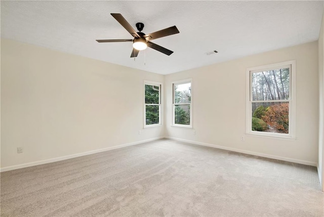 unfurnished room with light carpet and ceiling fan