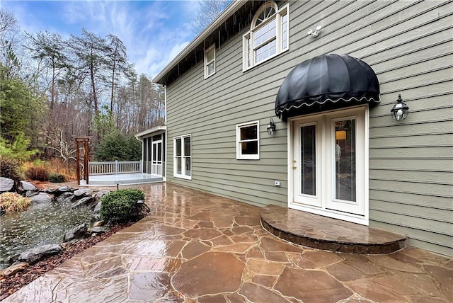 rear view of property featuring a patio area