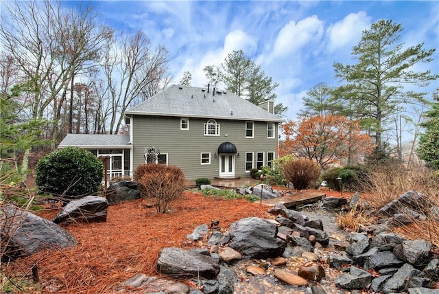 rear view of house with a patio and a sunroom