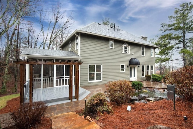 back of property with a sunroom and a patio